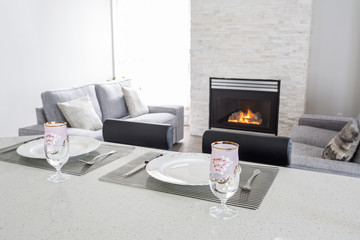 Bright and clean interior design of a luxury living room with hardwood floors, fireplace and sofa.