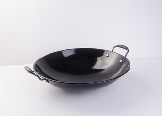 wok or asian cooking wok on a background. © heinteh
