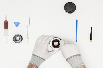 technician repairing broken camera lens, top view, flat lay
