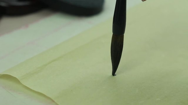 Draw a Line on the Vintage Paper. Learning to Write Characters Using a Brush For Calligraphy 1