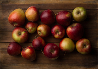 Organic small garden ripe apples on wooden plank