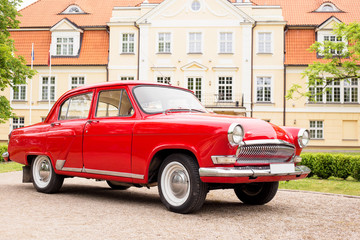 Red retro car in font of holiday villa