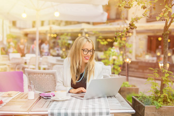 Woman in cafe working on laptop