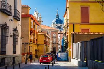 Colorful Madrid street and Almudena Cathedral view in Madrid, Spain
