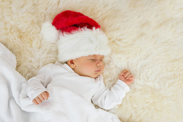 Fototapeta premium Baby sleeping with Christmas hat on