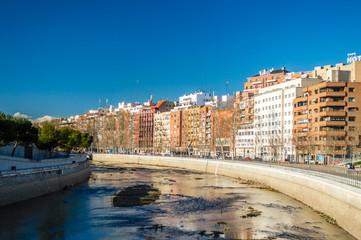 Fototapeta premium Apartment buildings on Manzanares river coast in Madrid, Spain