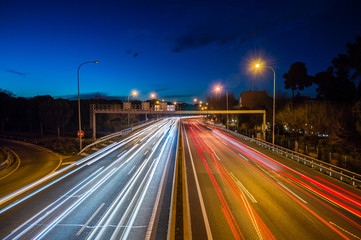 Speed Traffic - light trails on motorway highway at night, long exposure abstract urban background