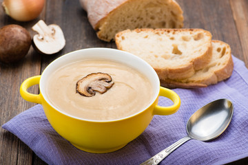 Mushroom cream soup on the wooden table.