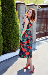 Woman in dress with red roses