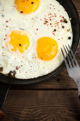 Fried eggs with pepper closeup