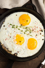fried eggs with thyme closeup