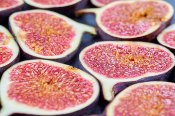 Pieces of fig on a stone board. Fruit background