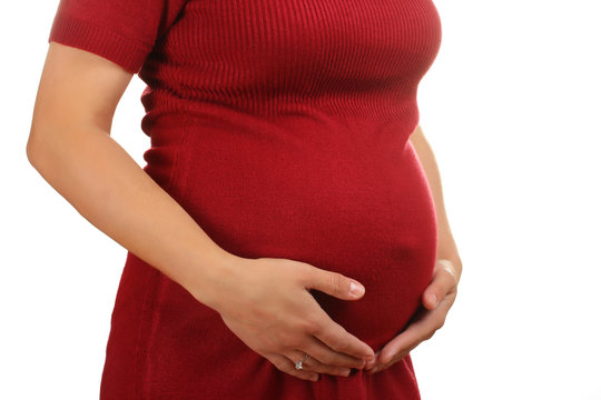 The image of the abdomen of a pregnant woman waiting for a child.