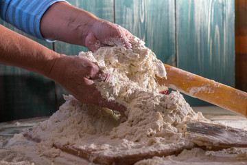 Woman knead dough with egg flour and water