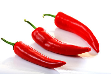 Three peppers on light background