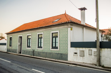 House near the road in portuguese village with typical traditional portuguese tiles on the wall in Portugal