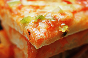 Melted cheese on pizza slice