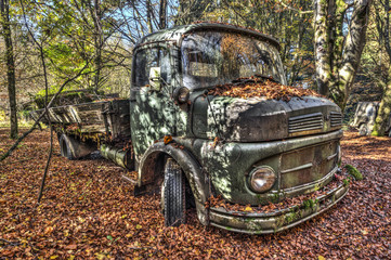 Old truck abandoned in a forest