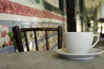 Close up of coffee cup on marble table in China Town, Singapore.