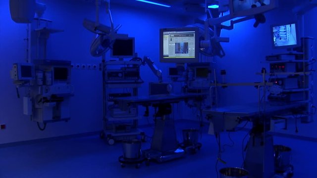 Wide shoot of operation room with blue light and screens on