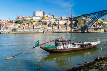 Fototapeta na wymiar Old Porto cityscape skyline, traditional boats with wine barrels and Douro River in Porto, Portugal