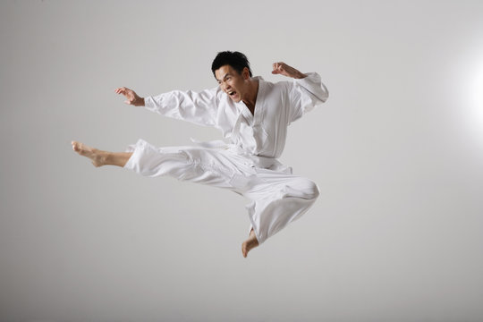 Man doing a flying kick, martial arts