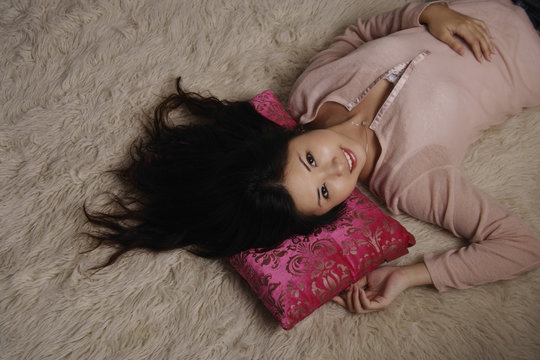Chinese woman laying on rug