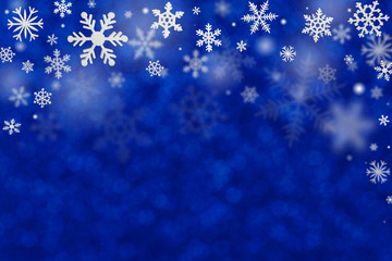 Fototapeta na wymiar Christmas decoration with snowflakes on defocused blue background.