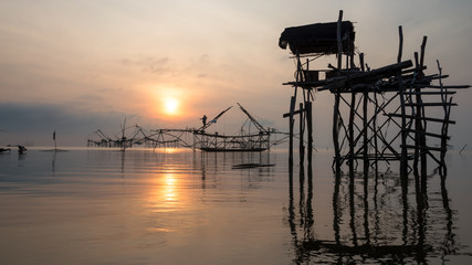 Fototapeta na wymiar Fisherman with giant square dip net at Pakpra canal, Phatthalung, Thailand.