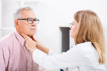 Obraz premium Doctor is examining glands in the neck of her patient.