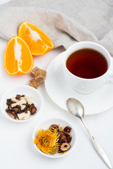 a mug of tea, oranges and berries