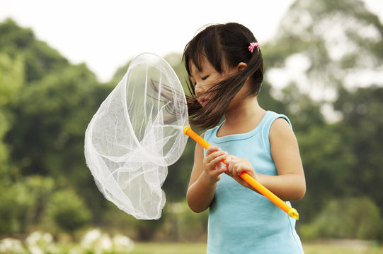 girl looking into butterfly net