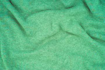 close up green knitted pullover background.