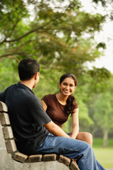 Couple sitting and talking on bench