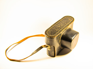Old soviet rangefinder camera in leather case on white backgroun