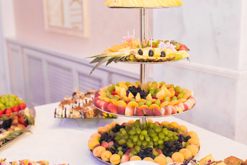 Delicious and tasty dessert table with cupcakes shots at reception closeup