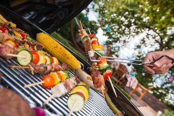 Assorted delicious grilled meat with vegetable on a barbecue - obrazy, fototapety, plakaty