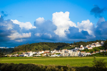 Fototapeta na wymiar Odeceixe cityscape - blue sky with clouds and white houses in Odeceixe, Portugal