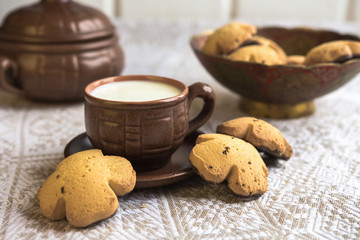 Breakfast in a rustic style, milk, biscuits, fruit in pottery
