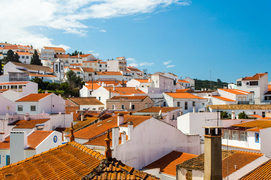 Odeceixe cityscape  - white houses with red roofs and blue sky in Odeceixe, Portugal