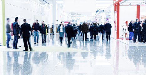 blurred business people trade fair stock photo