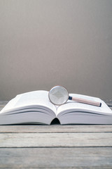 Magnifying glass and book