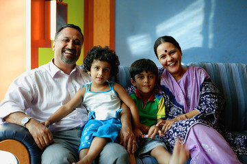 Family with two children, smiling at camera
