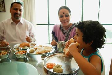 Family of three sitting down to a meal