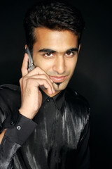 Man using mobile phone, looking at camera