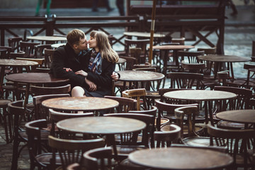 Fototapeta na wymiar beautiful and young couple sitting outside a cafe