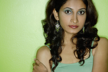 Young woman in green tank top, looking at camera
