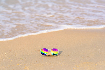 sunglasses lying on tropical sand beach