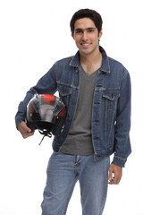 Man carrying motorcycle helmet, looking at camera