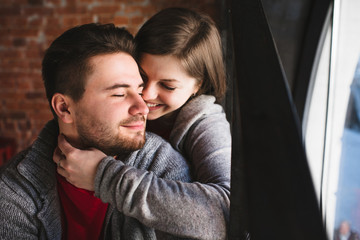 beautiful young couple sitting on red stairs